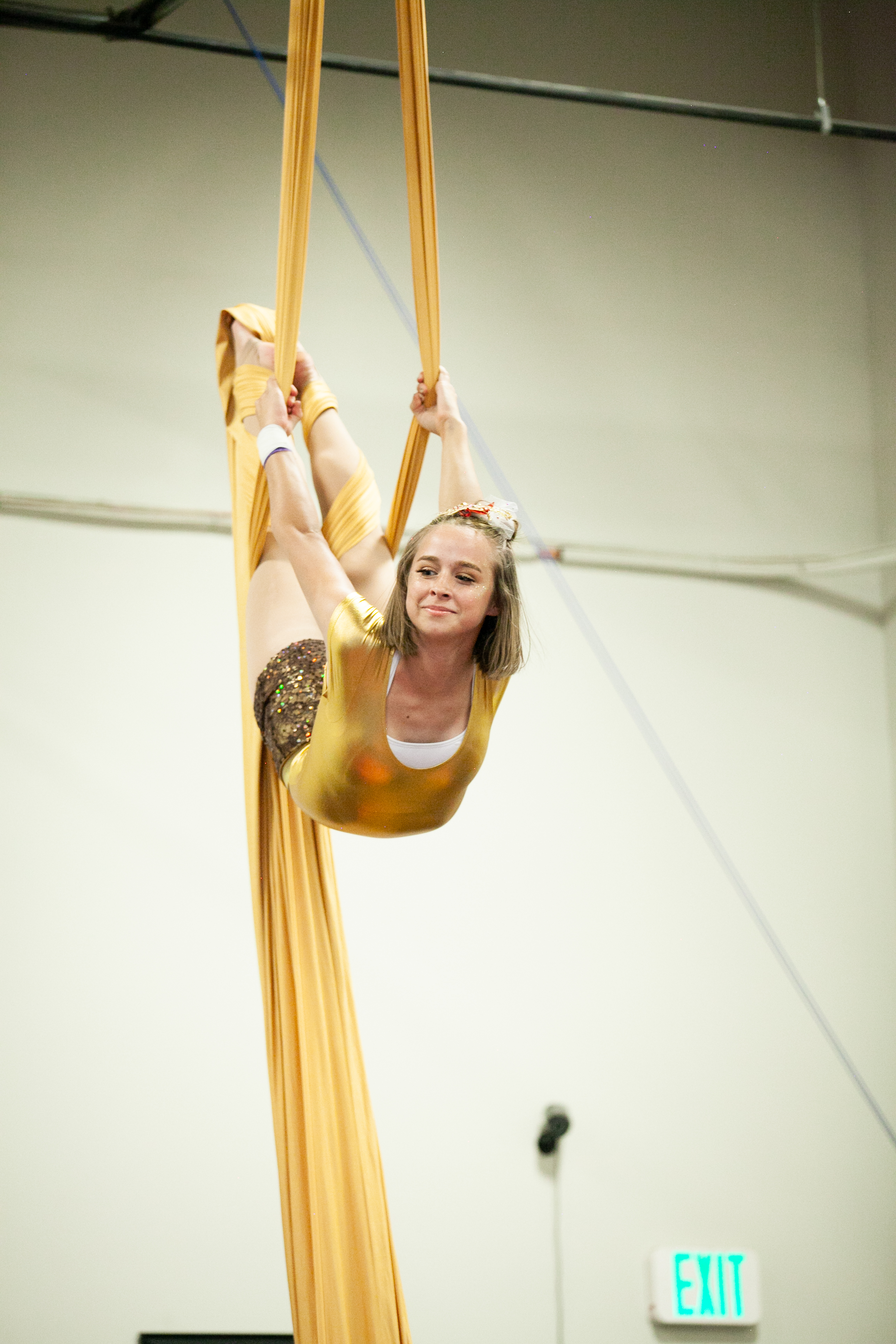 young blond performer in deep back bend pose